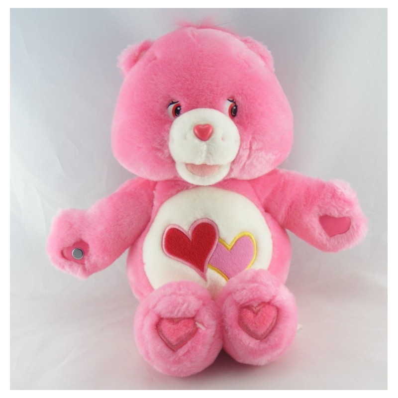 Peluche Bisounours chantante rose Groschéri avec 2 coeurs CARE BEARS